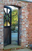 Wooden gate in brick wall. 