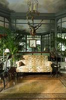 Interior with comfortable sofa and container grown palms 