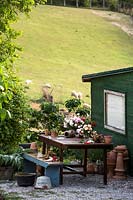 Table outside shed where cut flowers are prepared, view of field beyond 
