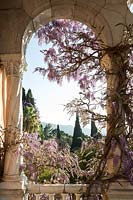 View through loggia facing south and once used for parties now houses an old specimen of wisteria