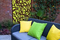 Cushions on sofa with Decorative Mural in Small Modern Garden 