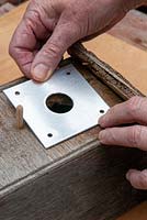 Fixing  metal plate on bird box to prevent hole enlargement by other predatory birds