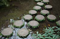 Circular stepping stones acting as a bridge over water 