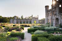 Parterre in front of castle with low blocks of Taxus - Yew - framing herbaceous perennials including Filipendula venusta 'Rubra' and Veronicastrum virginicum 'Spring Dew'