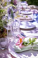 Table setting with fresh flowers and fabric napkins