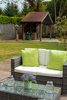 Rattan sofa and table on patio with outside kitchen beyond - Open Gardens Day, Nacton, Suffolk