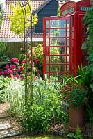 Recycled GPO telephone kiosk in border as a garden feature - Open Gardens Day, Palgrave, Suffolk
