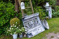 Display of vintage objects, potted plants and antique washstand