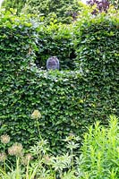 Owl sculpture placed in cut Beech - Fagus hedge