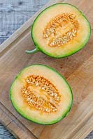 Melon 'Irina' halved to reveal the fresh and seeds inside
