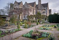 The Leisure Garden with a stone urn and variegated clipped box at its centre, Rodmarton Manor, Glos, UK. 