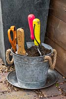 A bucket of coarse sand mixed with vegetable oil helps keep hand tools clean and rust free