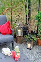 Large greenhouse with lounge furniture, cushions and lit candles in lanterns