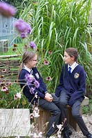 School pupils enjoying the garden at Sedlescombe Primary School, Sussex, UK.
