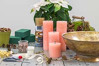 Materials and tools for creating an an indoor arrangement with houseplant and candles