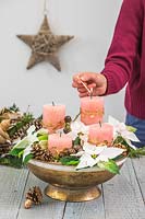 Lighting a candle in a bowl arrangement