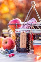 Selection of jams and jellys in Autumn with apples - german labels
