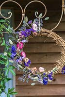 Dried flower wreath - blue and pink hanging on decorative metal frame