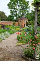 Borders and paths in front of the brick folly built in to the walls of the walled garden at Middleton Hall garden