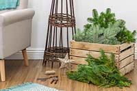 Materials and tools required to construct a space saving Christmas tree in modern living room
