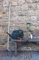 Essential garden tools of a Hoe, fork, trowel, watering can and secateurs