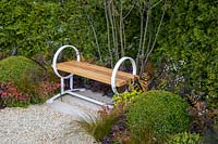 Contemporary wooden garden bench with a gravel path. Time is a Healer garden, RHS Malvern Spring Festival, 2016. Designer Martyn Wilson Associates