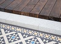 Decking on top of stone steps with mosaic tiled patio detail. The Style and Design Garden, sponsors CED Stone, London Mosaic, Garden Brocante Online - 