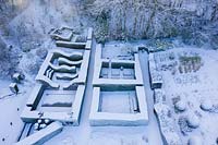 Drone overview of formal country garden covered in snow. Garden - Veddw 

