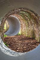 Tunnel made from concrete piping and weaved willow. The Thames Water Flourishing Future Garden - Hampton Court Flower Festival 2019