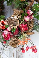 Detail of floral wreath with Hippeastrum, crab apples, pinecones, dried hydrangea flowers. Styling: Marieke Nolsen