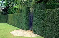 Metal gateway in Taxus baccata - Yew hedging. 