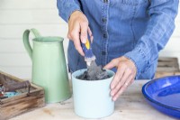 Woman mixing water and grout