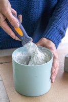 Woman mixing grout and water