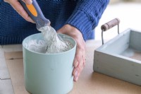 Woman mixing grout and water
