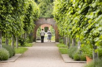 Elderly couple framed by arch in the South Gardens. June