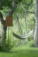 Poem on wood sign near hammock in between two trees.