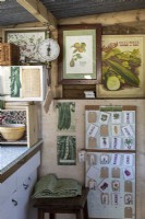 Interior of potting shed wall with vintage posters and scales
