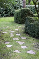 Paving stones set into grass in a random fashion at Dip-on-the-Hill, Ousden, Suffolk in August