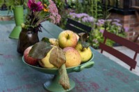 A bowl of apples on the garden table. 