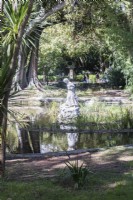 Sculpture of woman in the middle of the pond. Estrela district, Lisbon, Portugal, September. 