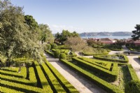 View over the Box Parterre of lines of clipped hedges with view to the River Tajus. Lisbon, Portugal, September.
