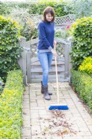 Woman sweeping patio