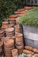 Stacked terracotta pots in work area of garden