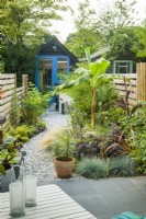 View into long narrow town garden in summer with garden studio. August