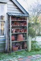 Home made shelving rack for storing collection of vintage terracotta flowerpots.