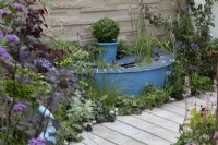'The Lillian Prime Trust Garden' - BBC Gardener's World Live 2021 - semi circular pond painted blue, bordered by perennials in pastel shades