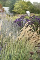 Autumnal grasses and flowering perennials with sculpture in the Hepworth Garden Wakefield