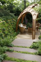 In The Meta Garden: Growing The Future, the steps leading to the sunken area are interspaced with moss, Selaginella kraussiana and bordered with woodland strawberries, Fragaria vesca - Designer: Joe Perkins - Sponsor: Meta.