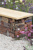 Insect hotel seating in the Turfed Out garden at RHS Hampton Court flower show 2022 - Designed by Hamzah-Adam Desai