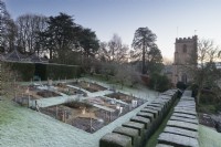 Formal kitchen garden at the Old Rectory, Netherbury, Dorset framed by yew hedges on a January morning.